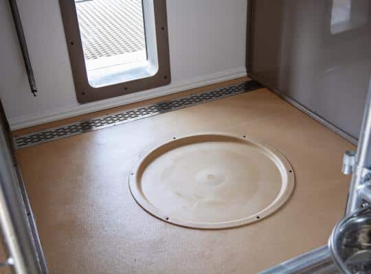 whelping pad inside dog kennel in floor