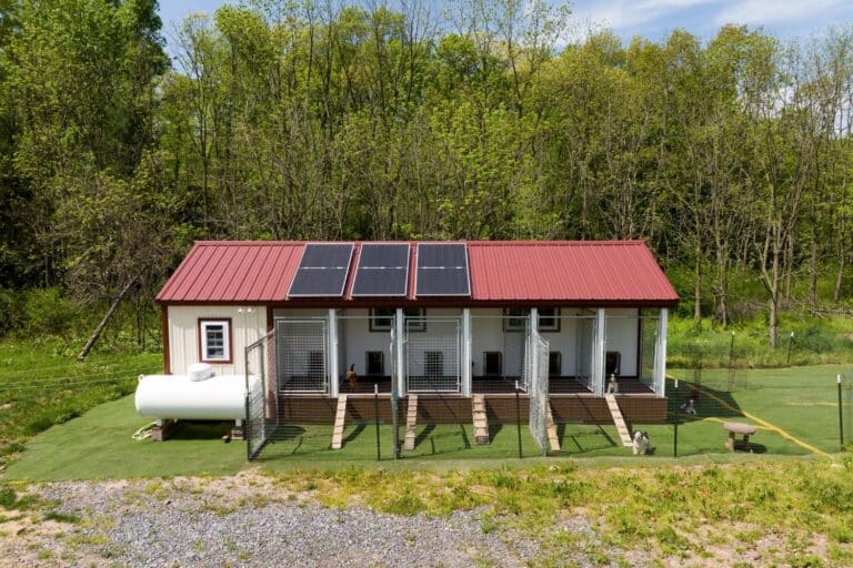 dog kennel with red roof with solar panels