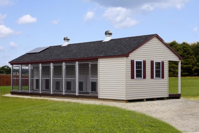 tan and red trim commercial dog kennel with shingle roof and multiple outdoor runs