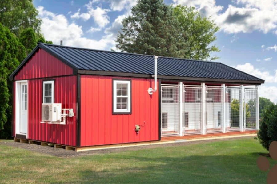 red dog kennel with black trim with outdoor runs for 5 dogs