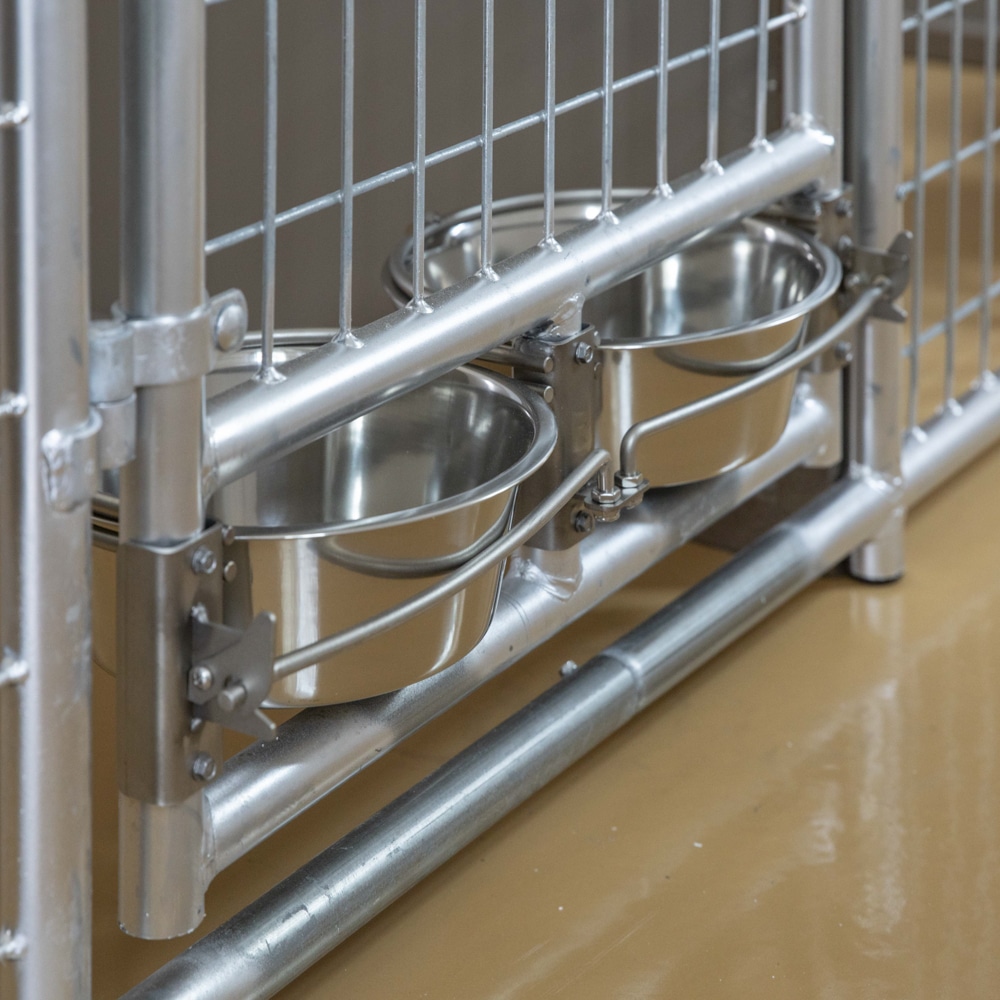 two feeder bowls inside kennel